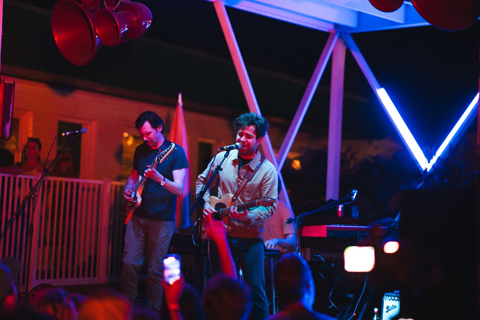 The band on the stage at the far end, under the light rig