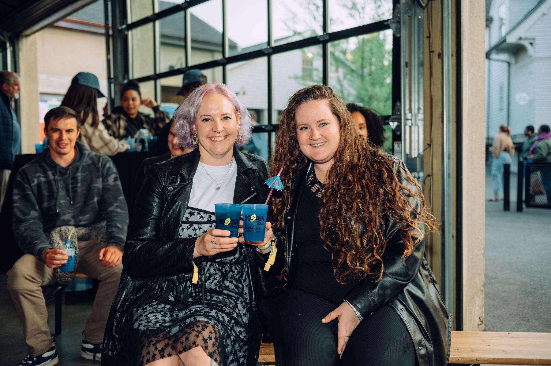 Two guests smiling with their drinks